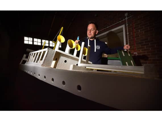Naval Warfare coordinater Damien Rhodes painting one of the boats