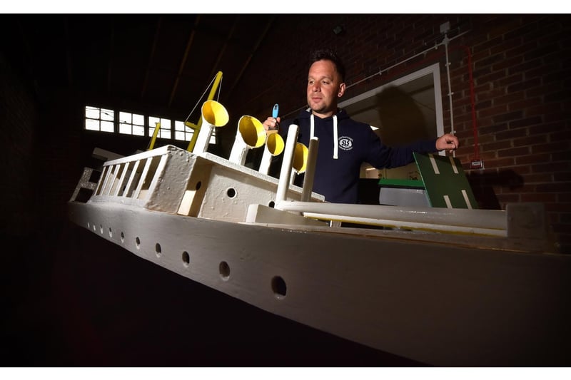 Naval Warfare coordinater Damien Rhodes painting one of the boats.
