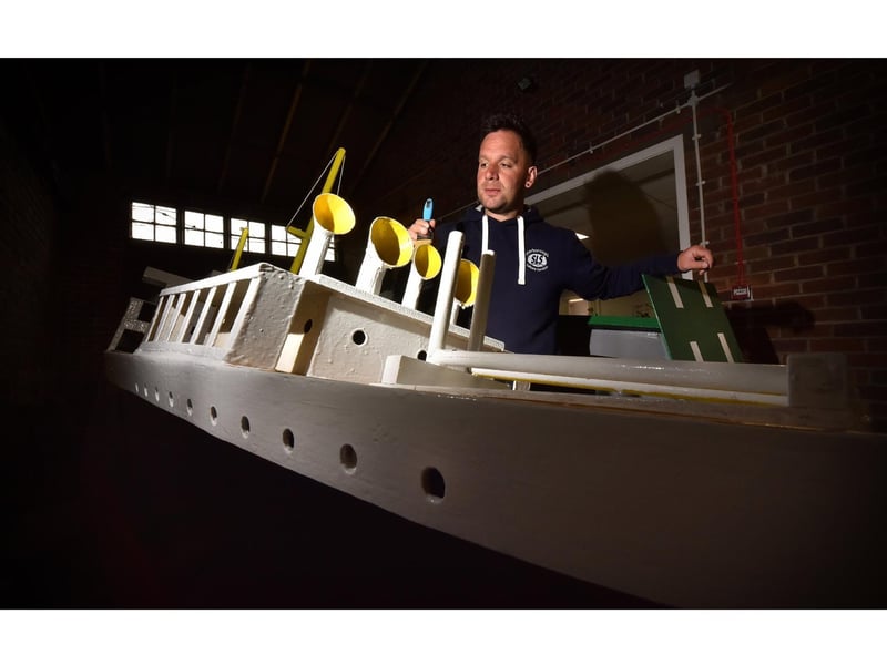 Naval Warfare coordinater Damien Rhodes painting one of the boats.