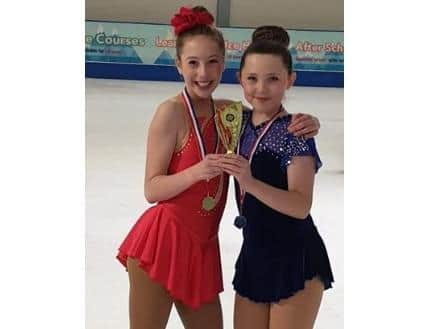Genevieve and Emily skating at the rink