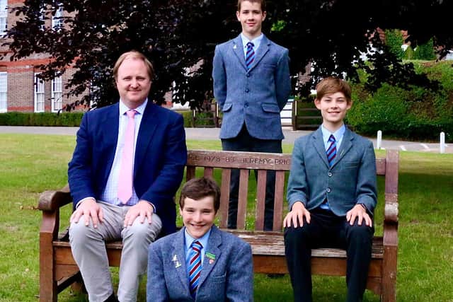 Headmaster Chris Wilson with three of the successful scholars