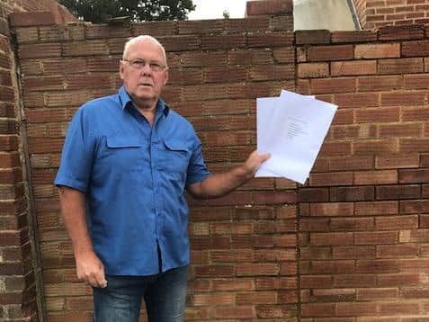 Richard, who has been asked by the other residents to act as the spokesperson, with the petition of signatures