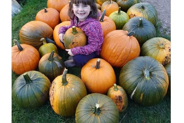 Lily with some of the pumpkins they grew at the allotment