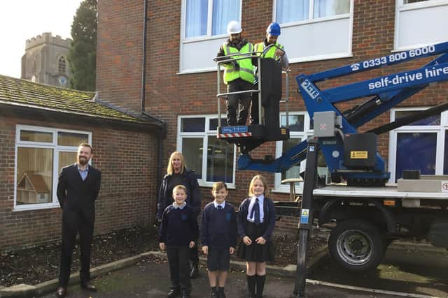 Installation of swift boxes high on school building, using cherry picker