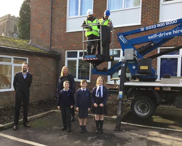 Installation of swift boxes high on school building, using cherry picker
