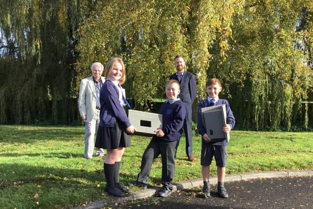 Cllr Douris and John Bell with three pupils