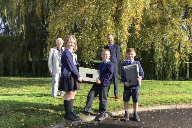Cllr Douris and John Bell with three pupils