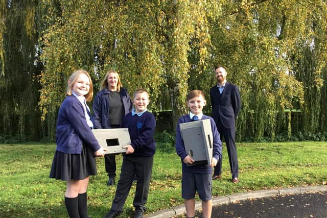 Lynne Osbourne and John Bell with three pupils