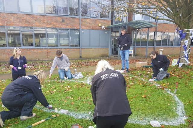 Volunteers from Epsonhelped  plant a giant snowdrop heart in honour of bereaved mums who donate their milk to help other babies