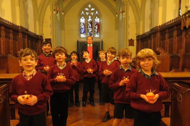 Pupils enjoying their Christingle Service with Headmaster Chris Wilson