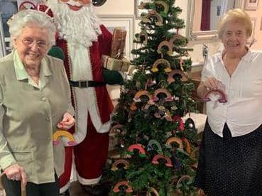 Residents Norma Blacker, 97, and Gloria Bence, 85 displaying some of the rainbows that have been painted to thank the community