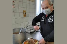 PCSO Simon Jackman serves up dinner for the homeless on Christmas Day