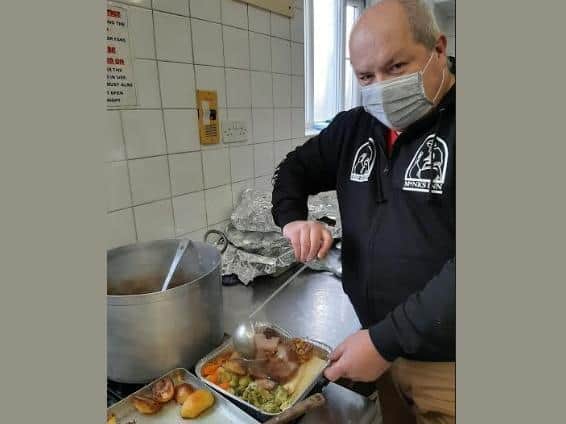 PCSO Simon Jackman serves up dinner for the homeless on Christmas Day