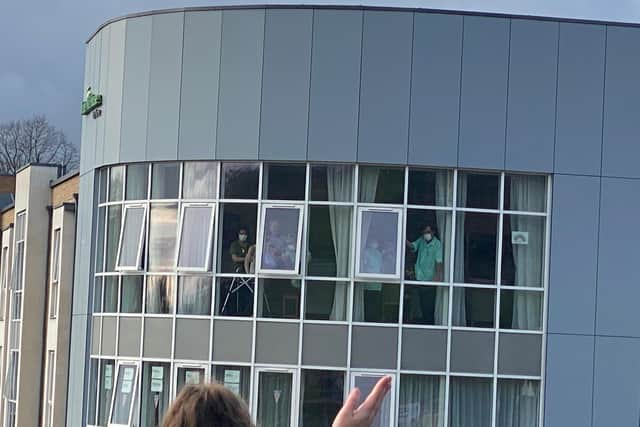 They waved and showed the residents their drawings, banners and pictures