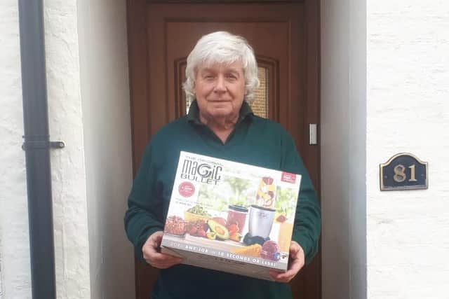 Pete Elsworth, chair of Age UK Dacorum Trust, gratefully receives the blender to be used for at the nutrition club