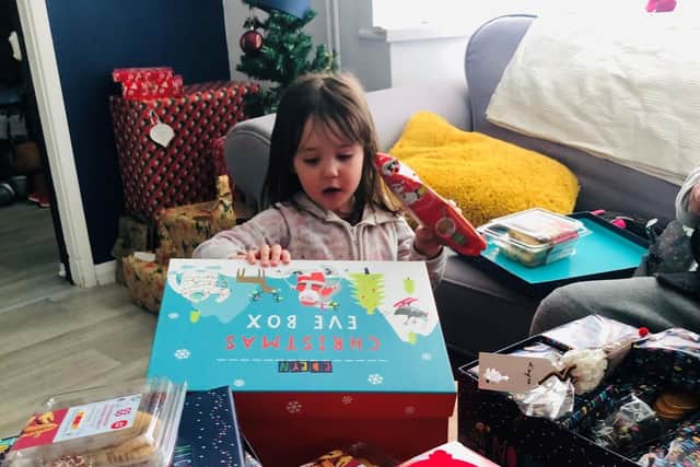 Jenny's daughter Edeyn-Rai enjoys her Christmas presents