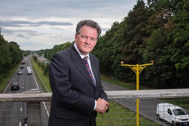 Mr Lloyd at A10 in front of new average speed cameras. The image is for illustration purpose only