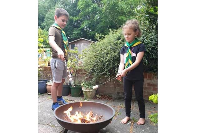 Toby and Carys (Leverstock Green) toasting marshmallows over a fire