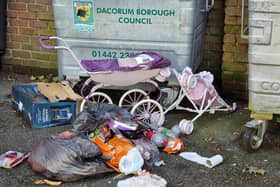 Rubbish dumped between the small block of flats on London Road