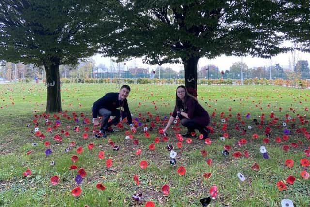 Head boy Sam and head girl Faith planting poppies