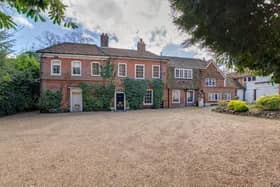 This detached home has an impressive ground floor with five reception rooms