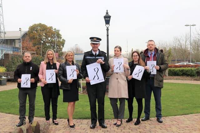 Chief Constable Charlie Hall (centre) with Head of Crime and Safeguarding Detective Chief Superintendent Kay Lancaster (left of Charlie) and Detective Chief Inspector Hannah Treadwell (right of Charlie) and other officers from the Domestic Abuse Investigation and Safeguarding Unit