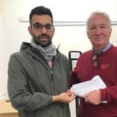Suliman Rafiq hands the petition over to Sir Mike Penning