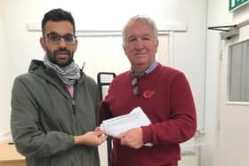 Suliman Rafiq hands the petition over to Sir Mike Penning
