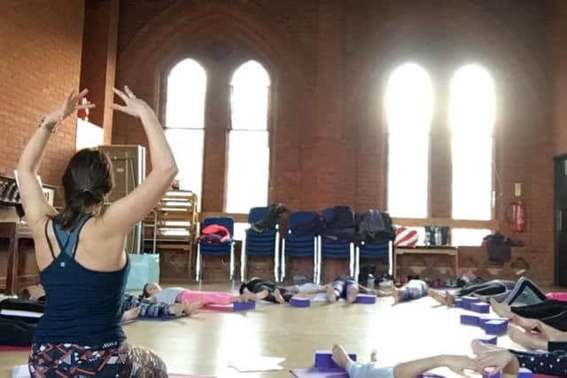 Emma teaching a mother and daughter yoga class
