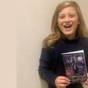 Nine-year-old Harry Bevan with his first book, The Magical Quests