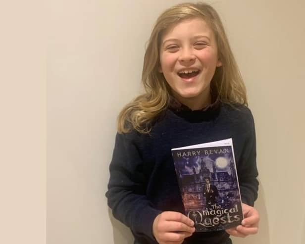 Nine-year-old Harry Bevan with his first book, The Magical Quests