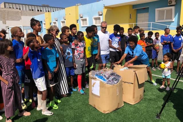 Jo and Paul and Carole Yearley travelled to Cape Verde where they handed out 600 second hand football boots and trainers to local children