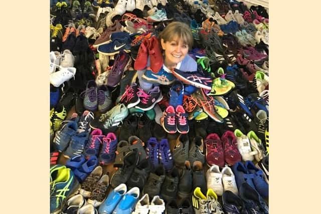 Jo with some of the donated pairs of trainers