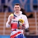 Hemel Hempstead's Max Whitlock shows off his gold medal after retaining his Olympic pommel horse title in Tokyo. Picture by Jamie Squire/Getty Images