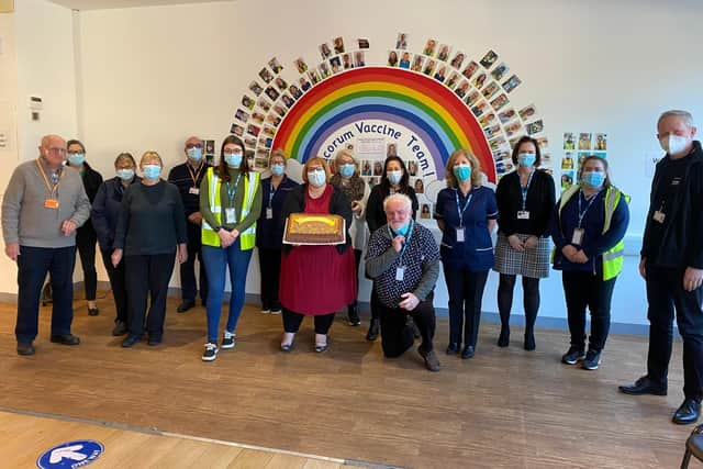 Emma Janes (holding the cake) celebrates Maxted Road’s anniversary with staff, volunteers and patients