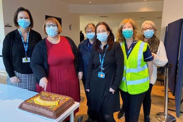 Emma Janes (cutting the cake) celebrates Maxted Road’s anniversary with staff, volunteers and patients