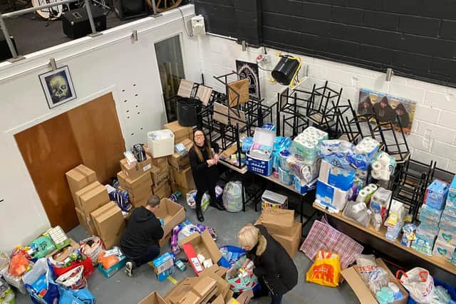 Volunteers surrounded by donations to the Ukraine appeal.