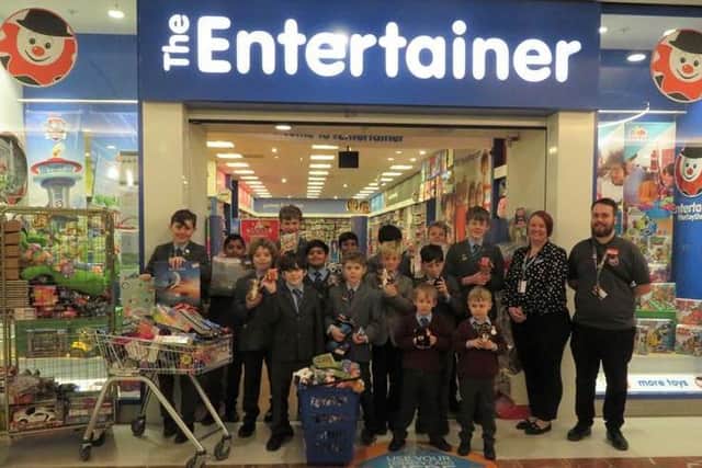 Lockers Park pupil with their toys outside The Entertainer