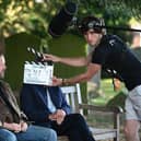 Ricky Gervais getting ready for one of many scenes which takes place on a bench, photo from Netflix