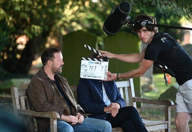 Ricky Gervais getting ready for one of many scenes which takes place on a bench, photo from Netflix