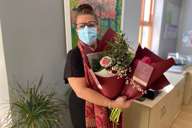 Karen from the Hospice’s reception team with the donated flowers