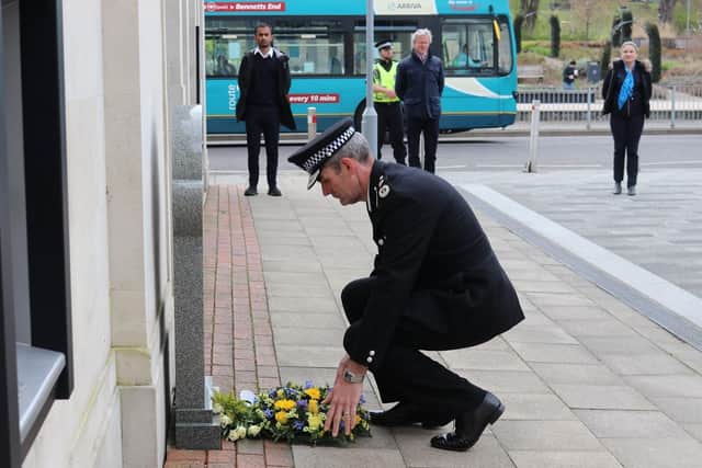 Chief Constable Charlie Hall laying a wreath at the site of PC Mason’s memorial stone in Bank Court