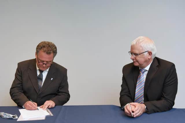 Mr Lloyd signing the oath with PARO Jeff Stack