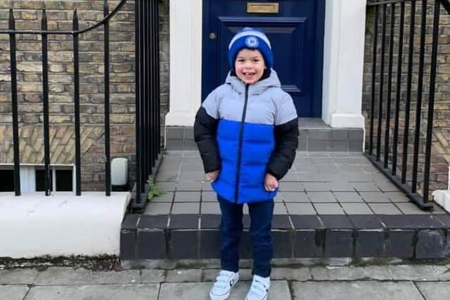 Joshua stood outside The Sick Children's Trust's Rainbow House where his parents were supported while he was in Great Ormond Street Hospital