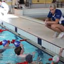 One of the club's coaches with some young swimmers