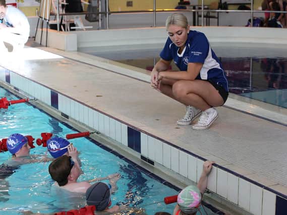 One of the club's coaches with some young swimmers