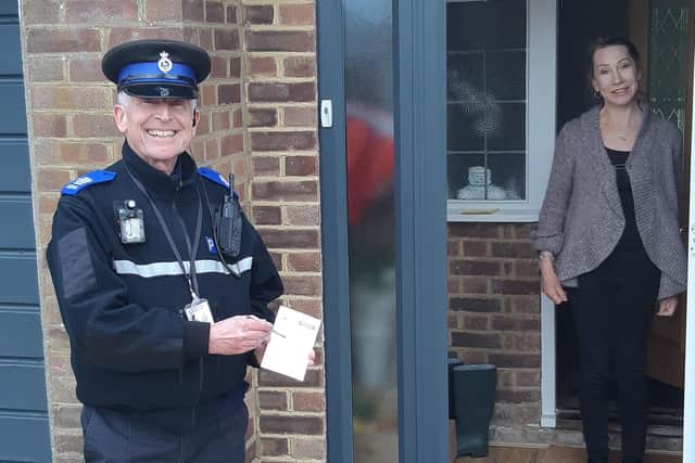 PCSO John Hainsworth with local resident, Jackie, signing up to OWL