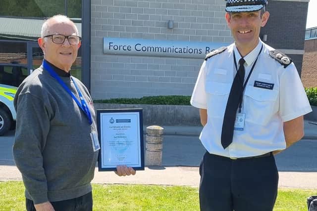 Volunteer Ben Richardson receiving his certificates from Charlie Hall