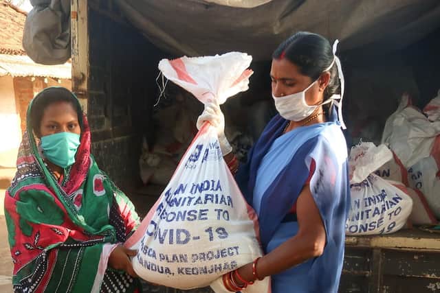 Women receives food kit in Odisha state