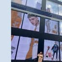 Angela in front of her work in Oxford Street